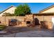 Outdoor kitchen and fireplace with built-in grill, stone counters, and flagstone patio at 16818 W Marconi Ave, Surprise, AZ 85388