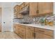 Sleek kitchen with stainless steel appliances and light wood cabinets at 20647 W Marshall W Ave, Buckeye, AZ 85396