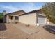 Tan house with white garage door and walkway at 2106 E Williams Dr, Phoenix, AZ 85024