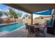 Covered patio with dining table and chairs, adjacent to the refreshing pool at 2106 E Williams Dr, Phoenix, AZ 85024