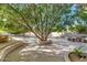 Landscaped backyard with mature trees and sitting areas at 2181 E La Vieve Ln, Tempe, AZ 85284