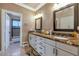 Double vanity bathroom with granite countertops and large mirrors at 2181 E La Vieve Ln, Tempe, AZ 85284