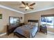 Well-lit bedroom with ceiling fan and dark wood furniture at 2181 E La Vieve Ln, Tempe, AZ 85284
