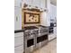 Stainless steel range, oven and vent hood in a gourmet kitchen at 2181 E La Vieve Ln, Tempe, AZ 85284
