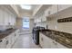 Bright laundry room featuring granite countertops and ample cabinet space at 2181 E La Vieve Ln, Tempe, AZ 85284
