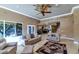 Bright living room with two sofas, a rug, and views of the backyard at 2181 E La Vieve Ln, Tempe, AZ 85284