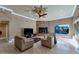 Living room with stone fireplace, two sofas and a large TV at 2181 E La Vieve Ln, Tempe, AZ 85284