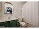 Clean bathroom with green vanity, shower/tub combo, and a classic mirror at 21956 W Casey Ln, Buckeye, AZ 85326