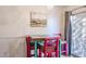 Quaint dining area with a unique wooden table and colorful chairs, next to a sliding glass door at 21956 W Casey Ln, Buckeye, AZ 85326