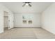 Well-lit bedroom with carpeting, ceiling fan, and a large closet at 28904 N Varnum Rd, San Tan Valley, AZ 85143