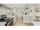 Modern white kitchen with island, stainless steel appliances, and ample counter space at 28904 N Varnum Rd, San Tan Valley, AZ 85143