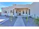 Covered entryway with columns, a dark-brown door, and desert landscaping at 31315 N 155Th St, Scottsdale, AZ 85262