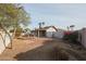 Spacious backyard with desert landscaping and a covered patio at 4901 W Augusta Cir, Glendale, AZ 85308