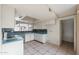 A galley kitchen with white cabinets, teal countertops, and tile flooring at 4901 W Augusta Cir, Glendale, AZ 85308