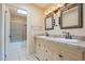 Bathroom with double vanity, large mirrors, and a separate shower and tub at 524 S Allred Dr, Tempe, AZ 85288