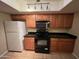 Galley kitchen with black appliances and granite countertops at 524 S Allred Dr, Tempe, AZ 85288