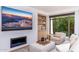 Living room with a modern fireplace and built-in shelving at 7175 E Camelback Rd # 109, Scottsdale, AZ 85251