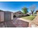 Landscaped backyard with storage shed and patio at 8539 W Flavia Hvn, Tolleson, AZ 85353