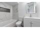 Elegant bathroom with marble tile, a white vanity, and a soaking tub at 8840 W Desert Cove Ave, Peoria, AZ 85345