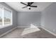 Spacious bedroom with grey walls, wood-look tile floors, and a ceiling fan at 8840 W Desert Cove Ave, Peoria, AZ 85345