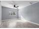 Bright bedroom with grey walls, wood-look tile floors, and a ceiling fan at 8840 W Desert Cove Ave, Peoria, AZ 85345
