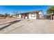 House exterior with a gated driveway and landscaping at 8840 W Desert Cove Ave, Peoria, AZ 85345