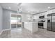 Modern kitchen with white cabinets, stainless appliances, and island at 8840 W Desert Cove Ave, Peoria, AZ 85345