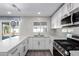 Modern kitchen features white shaker cabinets, stainless steel appliances, and quartz countertops at 8840 W Desert Cove Ave, Peoria, AZ 85345