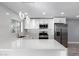 Modern kitchen with white cabinets, quartz counters, and island at 8840 W Desert Cove Ave, Peoria, AZ 85345