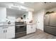 Modern kitchen with white cabinets, granite countertops, and stainless steel appliances at 10440 W Kingswood Cir, Sun City, AZ 85351