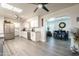 Bright kitchen with white cabinets, granite countertops, and views to dining area at 10440 W Kingswood Cir, Sun City, AZ 85351