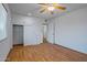 Bedroom with wood flooring and built-in shelving at 10447 W Pleasant Valley Rd, Sun City, AZ 85351