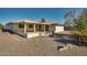 House exterior showcasing a covered patio and backyard at 10447 W Pleasant Valley Rd, Sun City, AZ 85351