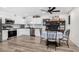 Modern kitchen with white cabinets, stainless steel appliances, and black countertops at 11428 N 57Th Ln, Glendale, AZ 85304