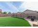 Artificial turf lawn, fire pit, and string lights enhance this beautiful backyard space at 12543 W Estero Ln, Litchfield Park, AZ 85340