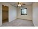 Bright bedroom with ceiling fan, window, and carpet flooring at 12757 W Myer Ln, El Mirage, AZ 85335