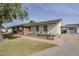 Brick and white exterior with a landscaped garden and carport at 1433 N Honeysuckle Ln, Gilbert, AZ 85234