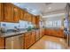 Large kitchen with wood cabinets, granite counters, and stainless steel appliances at 1433 N Honeysuckle Ln, Gilbert, AZ 85234