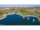 Aerial view of community pool, lake, and surrounding landscape at 16573 W Valencia Dr, Goodyear, AZ 85338