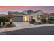 Beautiful stucco home with a 2-car garage, landscaping, and a mountain view at 16573 W Valencia Dr, Goodyear, AZ 85338