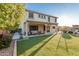 Two story home with covered patio, artificial turf, and pool view at 16922 W Adams St, Goodyear, AZ 85338