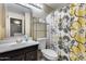 Clean bathroom with dark vanity and floral shower curtain at 18836 N 34Th Ln # 3, Phoenix, AZ 85027