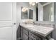 Bathroom with granite countertop and gray cabinets at 19404 W Minnezona Ave, Litchfield Park, AZ 85340