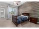 Bedroom with full-size bed and wood accent wall at 19404 W Minnezona Ave, Litchfield Park, AZ 85340