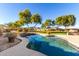 Freeform pool with large grassy backyard and mountain views at 19404 W Minnezona Ave, Litchfield Park, AZ 85340