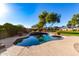 Freeform pool surrounded by lush landscaping, and mountain views at 19404 W Minnezona Ave, Litchfield Park, AZ 85340