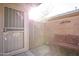 Small patio with bench and security door entry at 313 S 125Th Ave, Avondale, AZ 85323