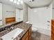 Bathroom with granite countertop, wood cabinets and a bathtub at 3434 W Danbury Dr # A212, Phoenix, AZ 85053