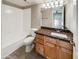 Bathroom with granite countertop, wood cabinets and shower at 3434 W Danbury Dr # A212, Phoenix, AZ 85053