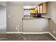 Kitchen features wood cabinets and granite countertops at 3434 W Danbury Dr # A212, Phoenix, AZ 85053